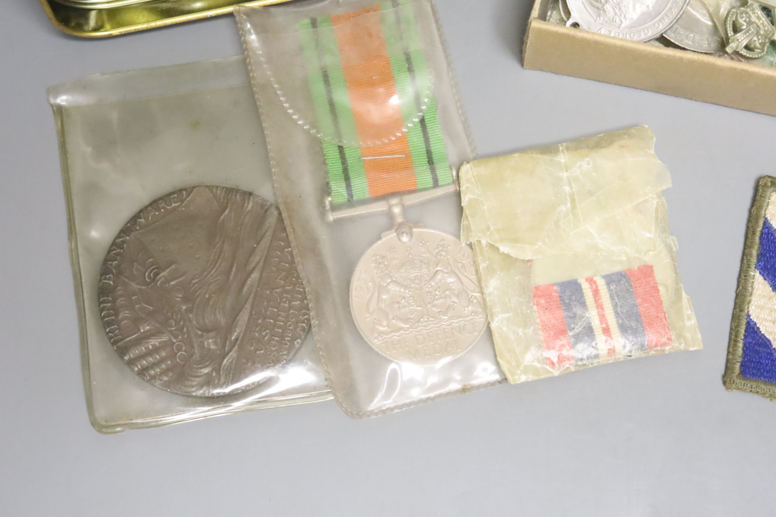 A WWII medal group, other military medals, cap badges etc.